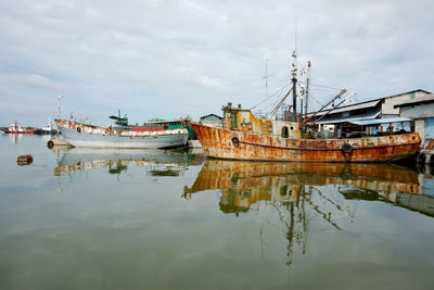 Old fishing boat in cinefuego. small port. rusty, distressed. calm day.