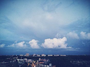 Buildings against cloudy sky