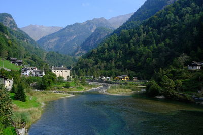 Scenic view of river amidst buildings against sky