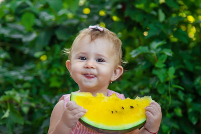 Smiling girl eating watermelon