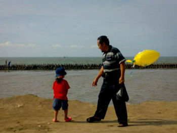 Full length of boys playing on beach