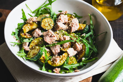 Fresh salad with arugula, baked zucchini and tuna. the concept of healthy and nutritious food.