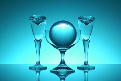 Crystal balls in glass against blue background