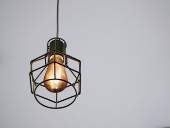 Low angle view of illuminated lamp against clear sky