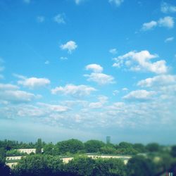 View of cityscape against cloudy sky