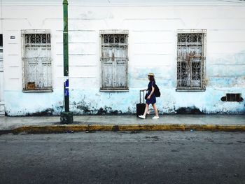 Full length of woman standing on railing