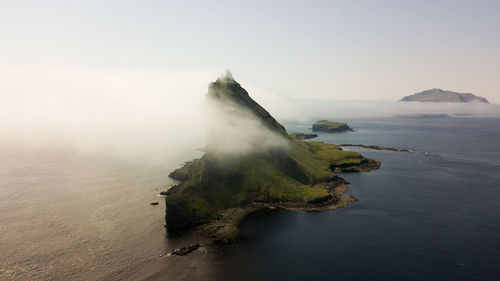 Aerial view of island against sky during sunset