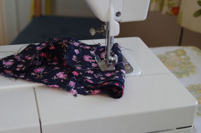 Close-up of textile on sewing machine at home