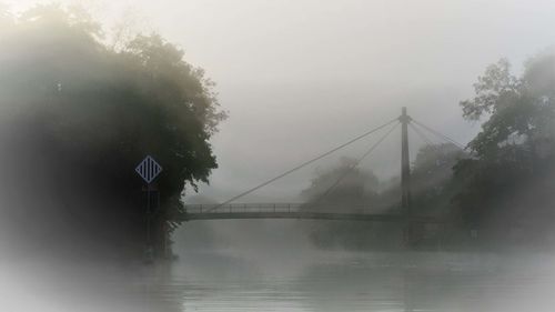 Bridge over river against sky