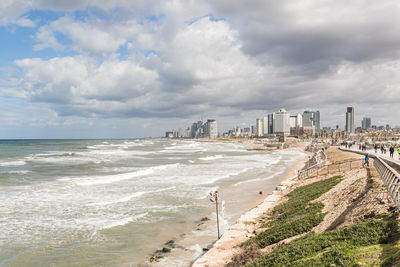Scenic view of beach against sky in city