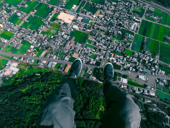 Low section of man flying above city