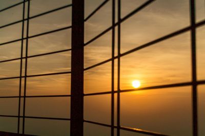 Close-up of silhouette built structure against sunset sky