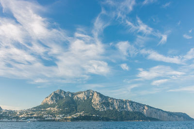 Scenic view of sea and mountains against sky