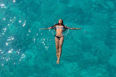 High angle view of woman swimming in sea