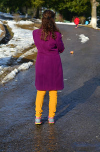 Full length rear view of man standing outdoors