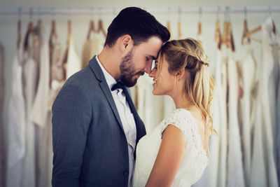 Rear view of couple standing against wall