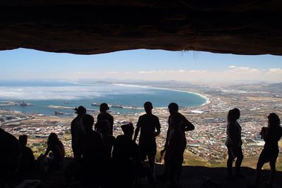 People at table mountain looking view of sea and cityscape