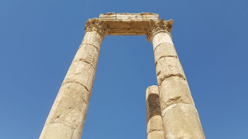 Low angle view of historical building against clear blue sky