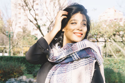 Portrait of smiling young woman in park