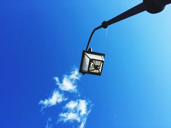 Low angle view of street light against blue sky during sunny day