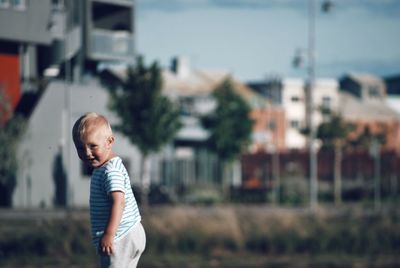 Portrait of cute boy standing outdoors