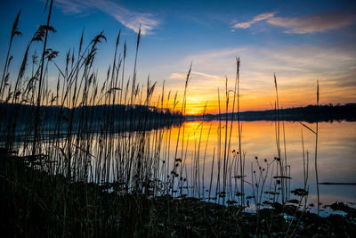 Scenic view of lake against sky at sunset