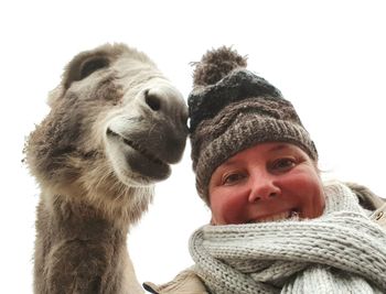 Portrait of smiling woman wearing hat during winter
