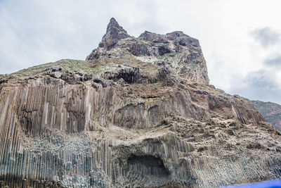 Low angle view of rock formation against sky