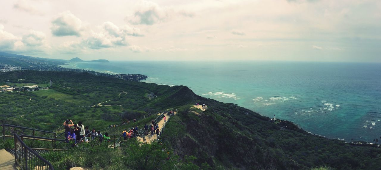 nature, mountain, beauty in nature, sky, scenics, high angle view, tranquil scene, outdoors, sea, tranquility, water, real people, tree, cloud - sky, vacations, large group of people, landscape, people, day, adult, adults only