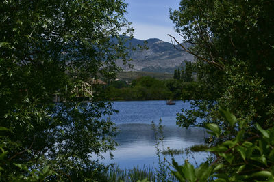 Scenic view of lake and mountains against sky