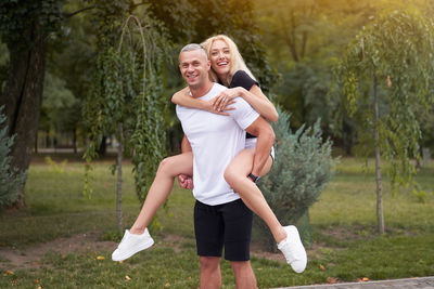 Portrait of smiling couple standing in park