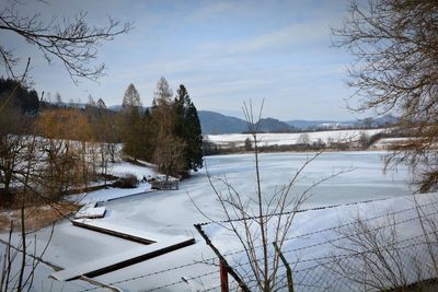 Scenic view of frozen lake against sky during winter