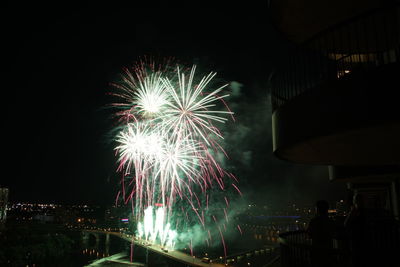 Low angle view of firework display at night