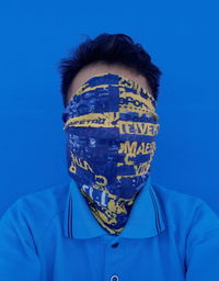 Portrait of man against blue background