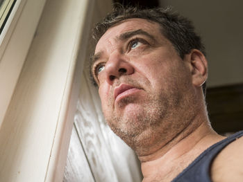 Low angle view of man looking away at home