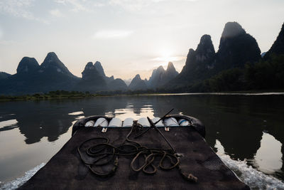 Scenic view of lake by mountains against sky