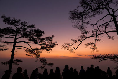 Silhouette people against sky during sunset