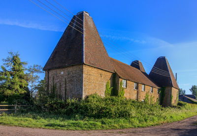 Old building on field against sky