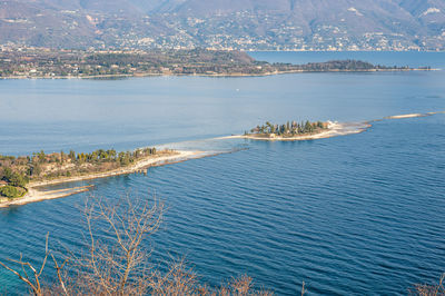 Aerial view of the lake garda with the rabbit island and the garda island from manerba