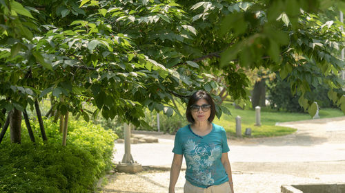 Woman walking under the tree