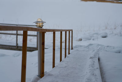 Wooden posts on snow covered land
