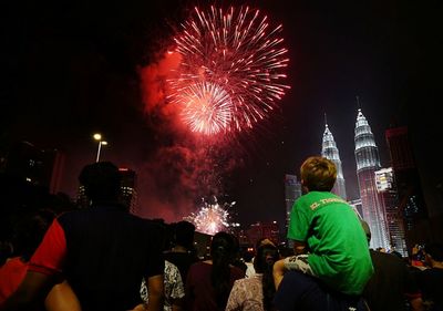 Rear view of a firework display at night