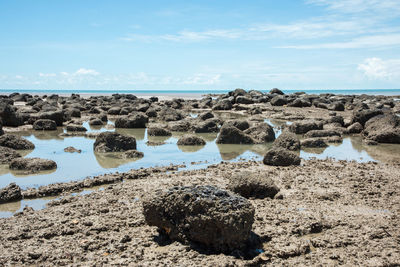 Rocks on beach against sky