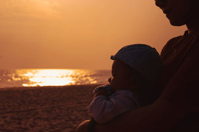 Midsection of woman with baby