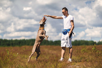 Full length of man standing on field against sky