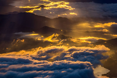 Scenic view of cloudscape and mountains during sunset