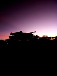 Silhouette landscape against sky at dusk