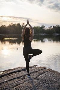 Woman at lake doing yoga