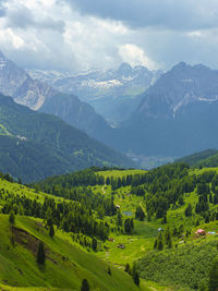 Scenic view of field and mountains against sky