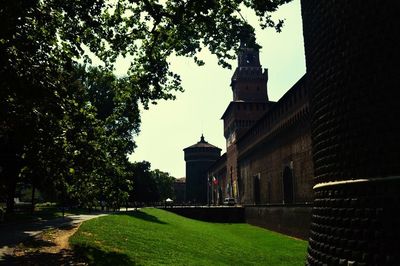 View of lawn with buildings in background